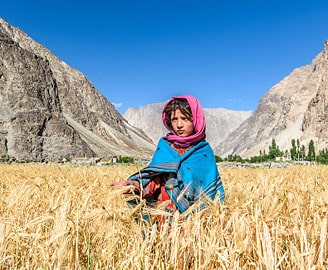 Girl in a field during harvest, Ladakh in autumn