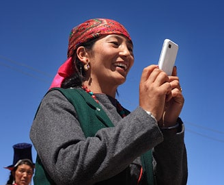 Ladakhi woman with a cell phone, Leh, Ladakh