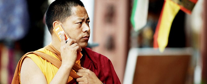 Monk calling with a mobile phone, Ladakh